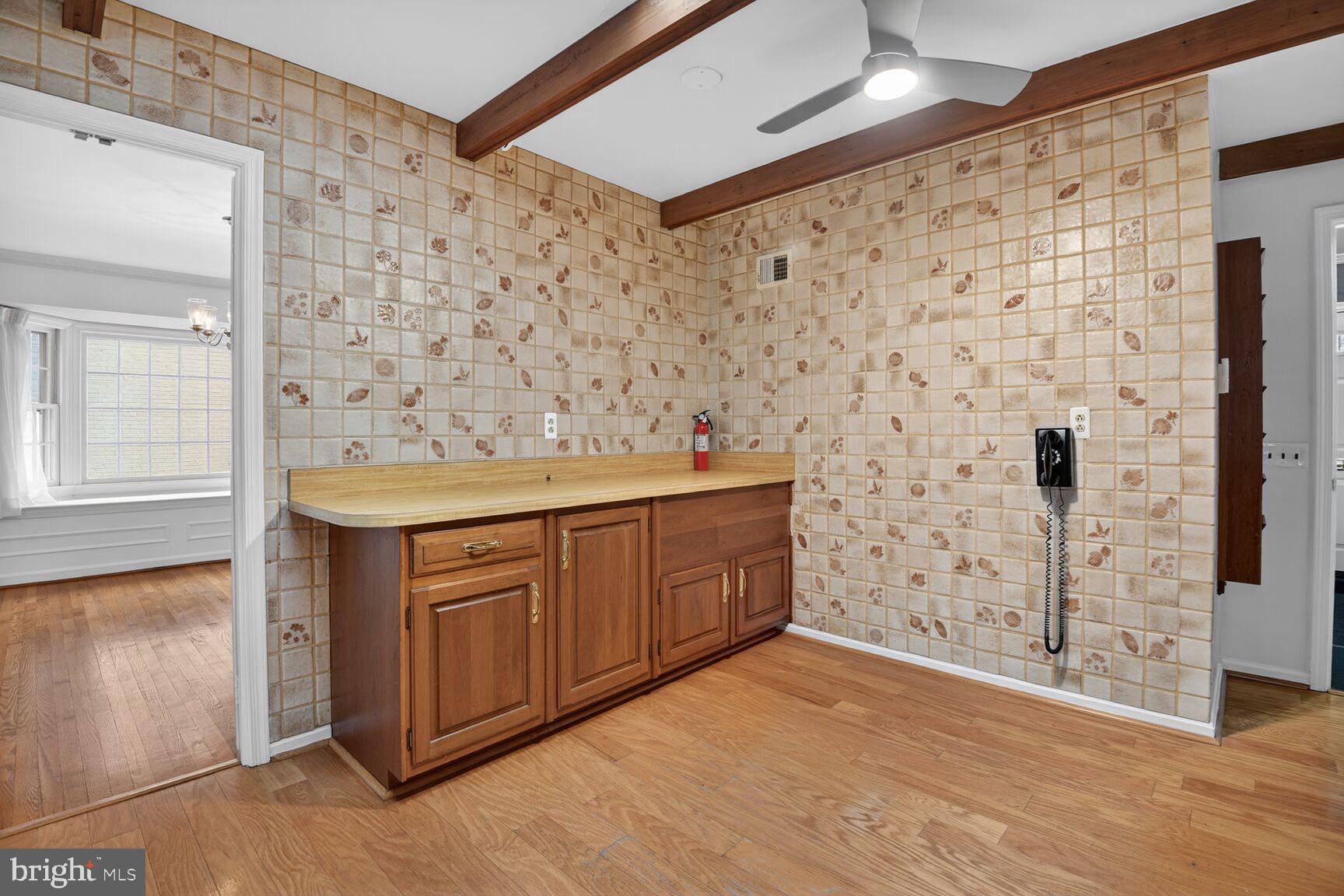 4709 River Road Bethesda, MD 20816 - Photo 12 of 25 a bathroom with a sink a mirror and shower