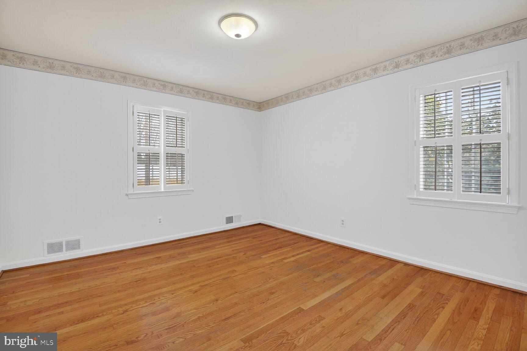 4709 River Road Bethesda, MD 20816 - Photo 15 of 25 a view of empty room with wooden floor and fan