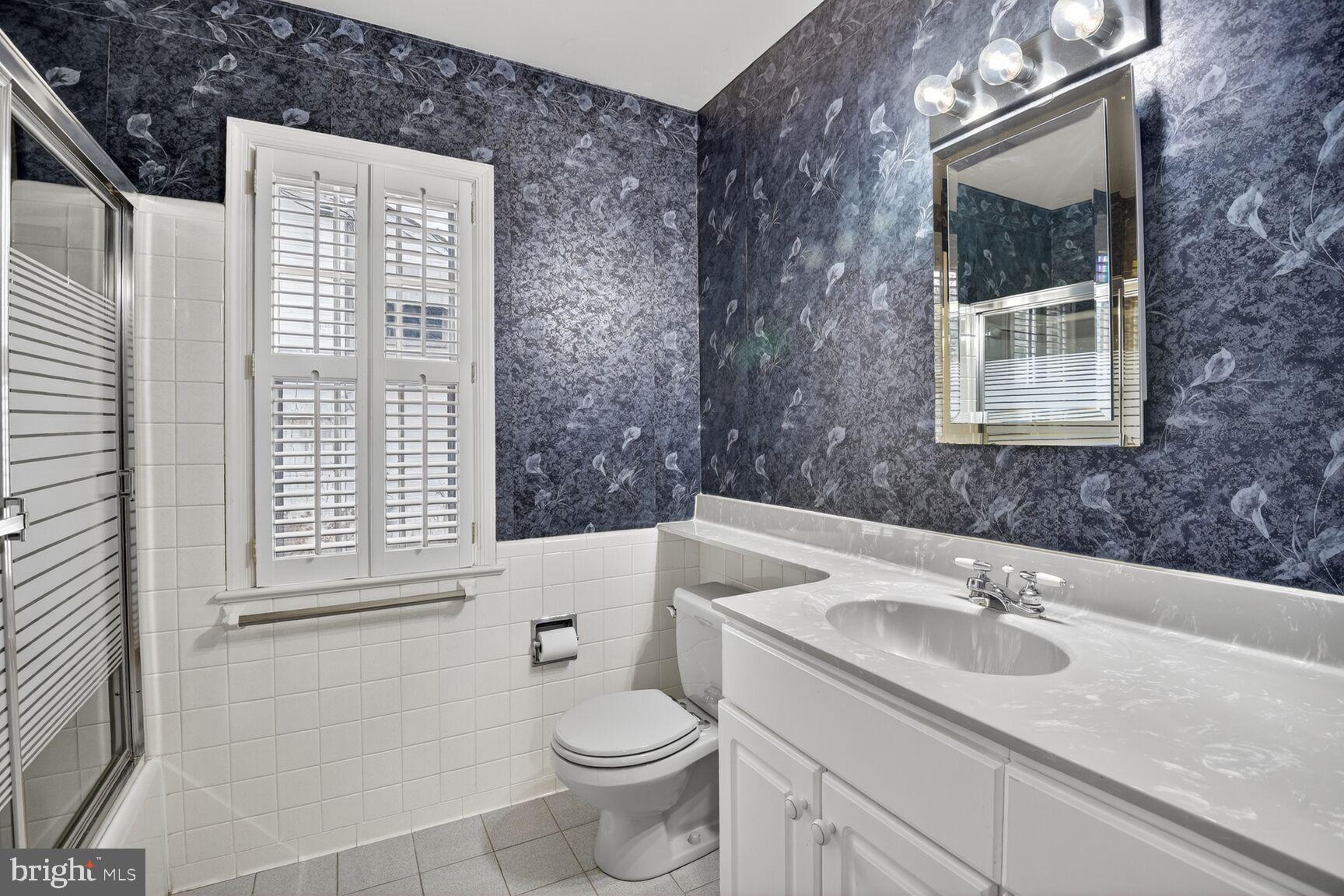 4709 River Road Bethesda, MD 20816 - Photo 16 of 25 a bathroom with a sink a toilet and shower