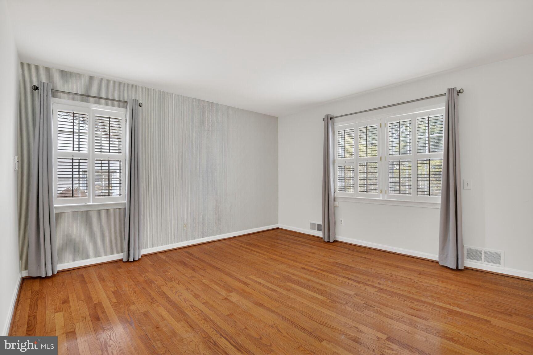 4709 River Road Bethesda, MD 20816 - Photo 17 of 25 a view of an empty room with wooden floor and a window