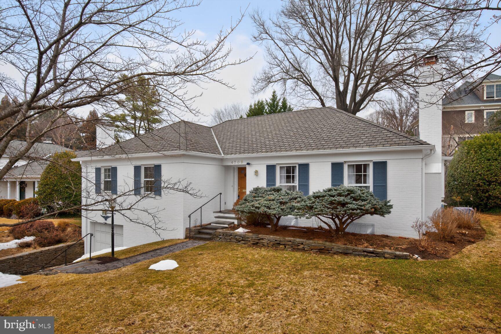 4709 River Road Bethesda, MD 20816 - Photo 2 of 25 a front view of a house with yard and outdoor seating