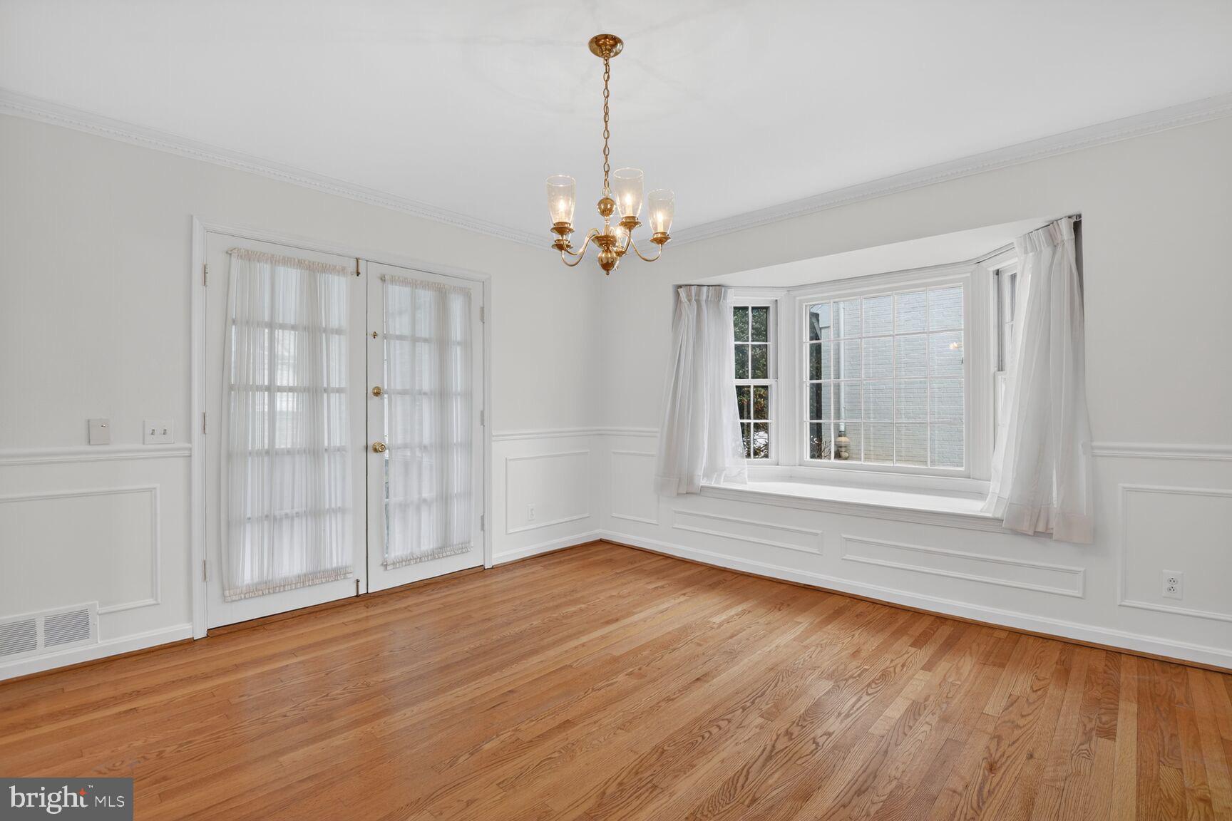 4709 River Road Bethesda, MD 20816 - Photo 9 of 25 a view of an empty room with a window and wooden floor