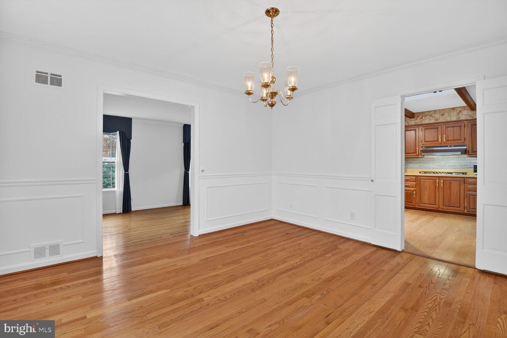 4709 River Road Bethesda, MD 20816 - Photo 10 of 25 a view of a kitchen with wooden floor and a ceiling fan