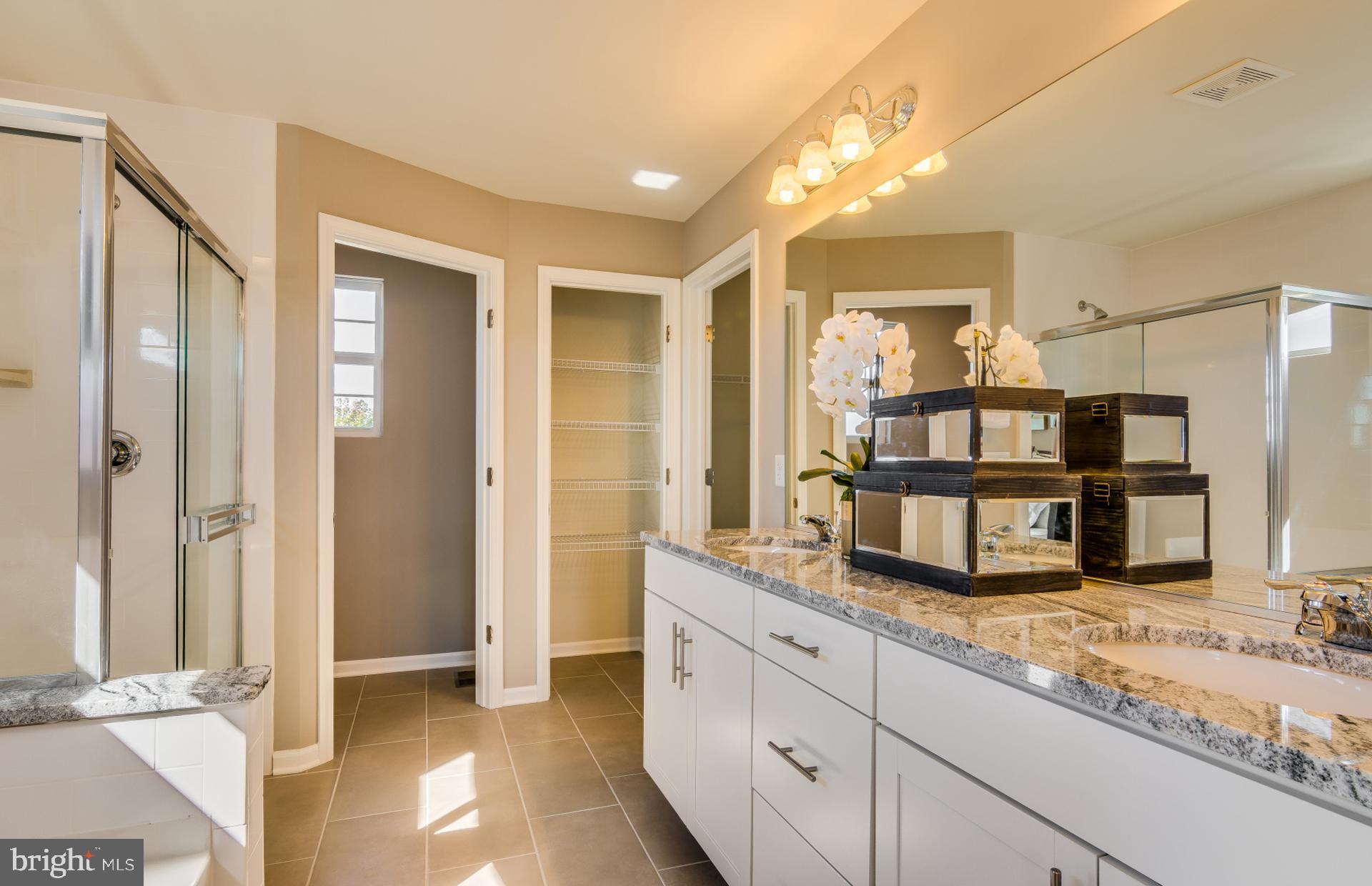 14528 Sourgum Road Boyds, MD 20841 - Photo 11 of 18 a kitchen with granite countertop a sink and a refrigerator