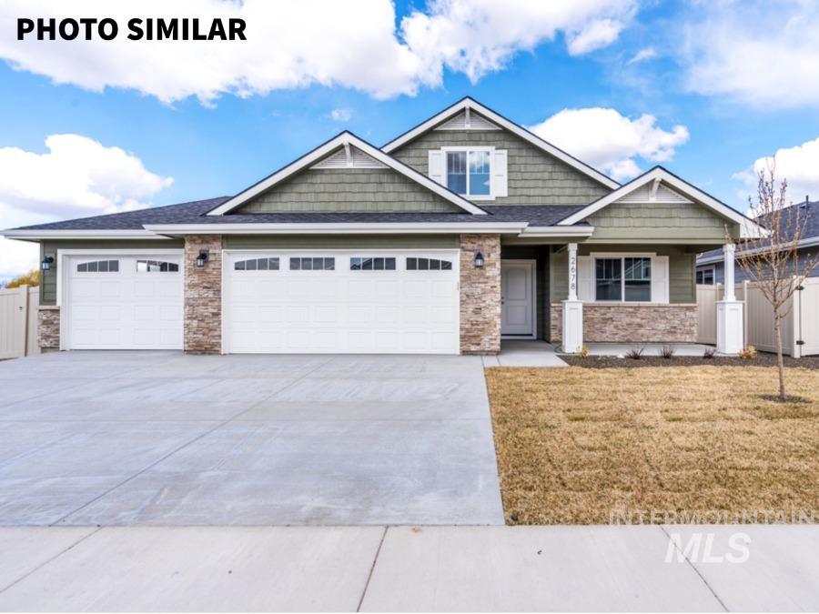 925 Twilight Weiser, ID 83672 - Photo 1 of 31 Contemporary single-story residence featuring a two-car garage with arched window inserts, stone accent facade, and a covered entry porch