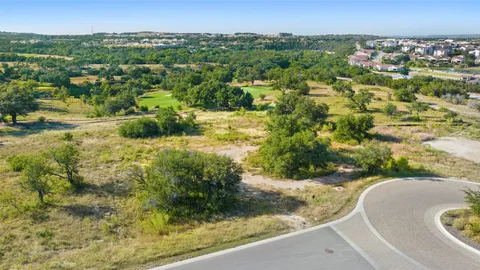 an aerial view of residential houses with outdoor space and trees