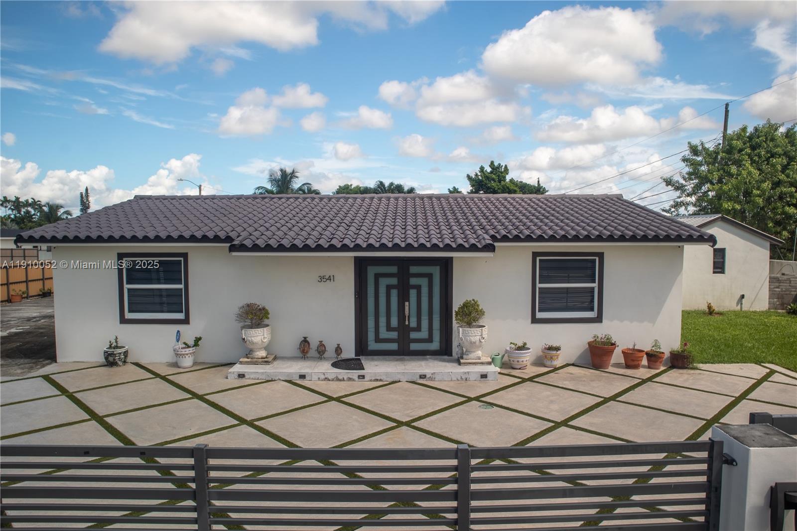 3541 Southwest 105th Court Miami, FL 33165 - Photo 1 of 22 a backyard of a house with table and chairs