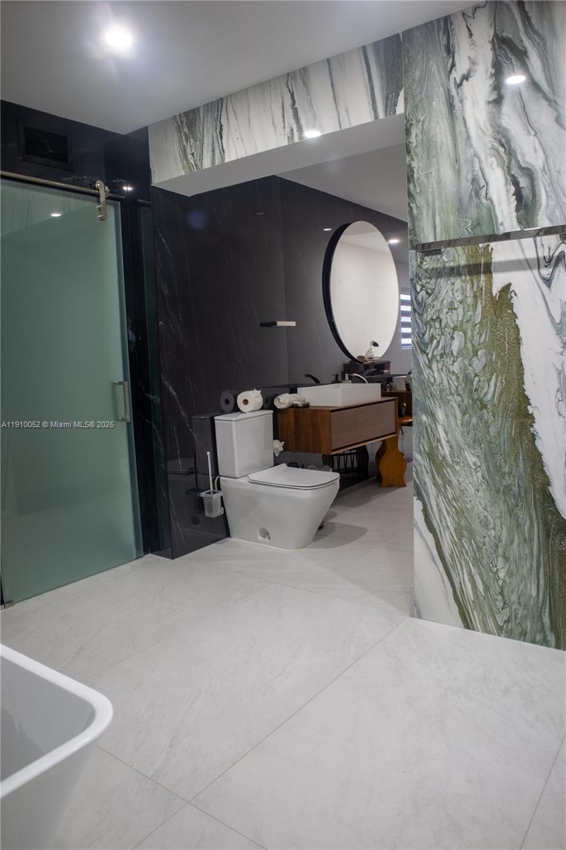 3541 Southwest 105th Court Miami, FL 33165 - Photo 11 of 22 a bathroom with a sink mirror vanity and toilet