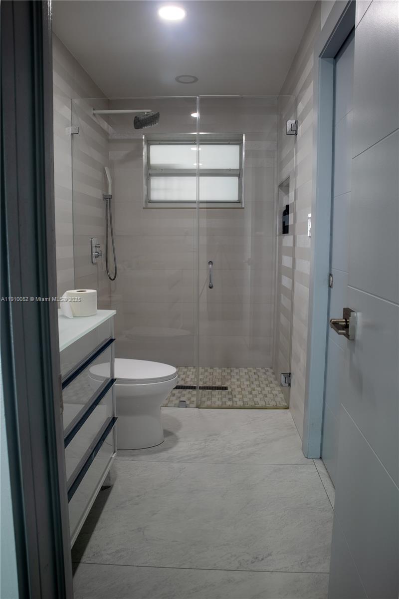 3541 Southwest 105th Court Miami, FL 33165 - Photo 15 of 22 a bathroom with a granite countertop sink a toilet and shower