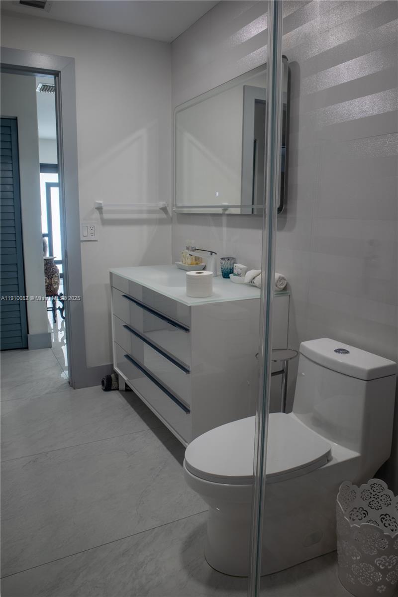 3541 Southwest 105th Court Miami, FL 33165 - Photo 16 of 22 a bathroom with a sink a toilet and mirror