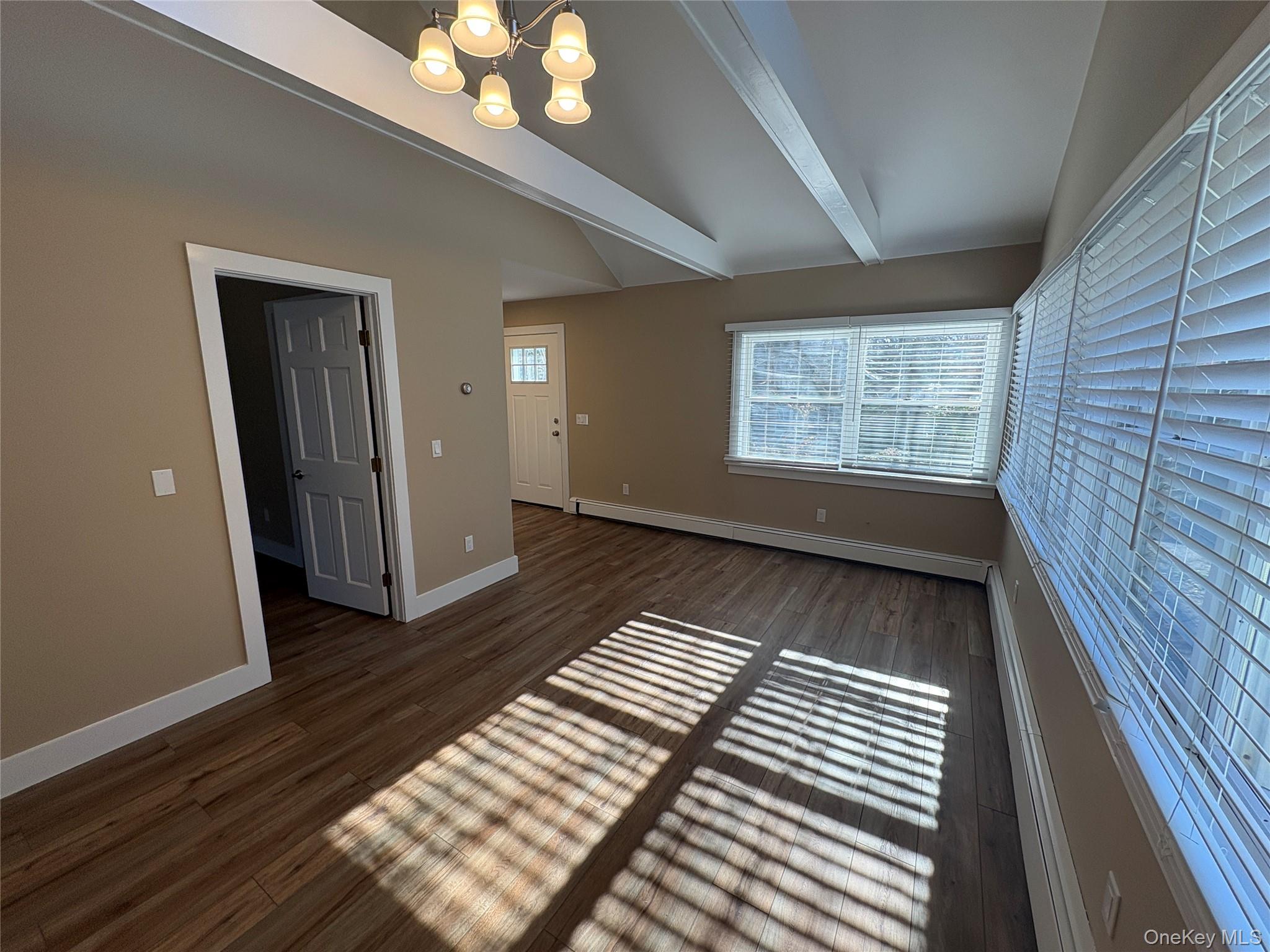 49925 Main Road Southold, NY 11971 - Photo 8 of 17 a view of an empty room with wooden floor and a window