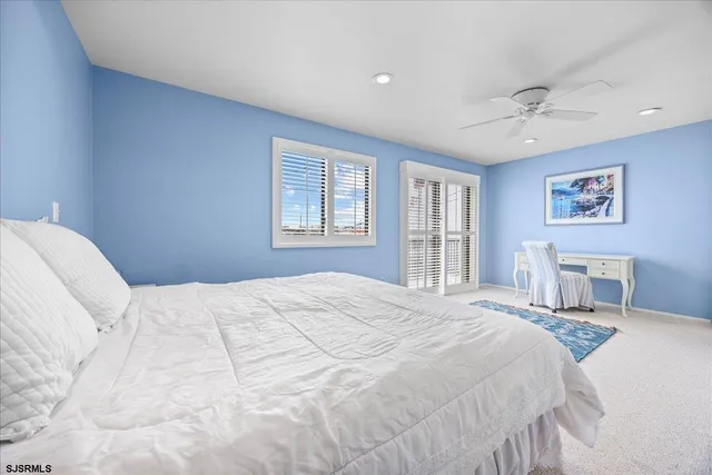 a bedroom with a large bed and a window