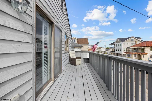 a view of a balcony with wooden floor