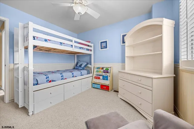 a bedroom with a bed dresser and a window