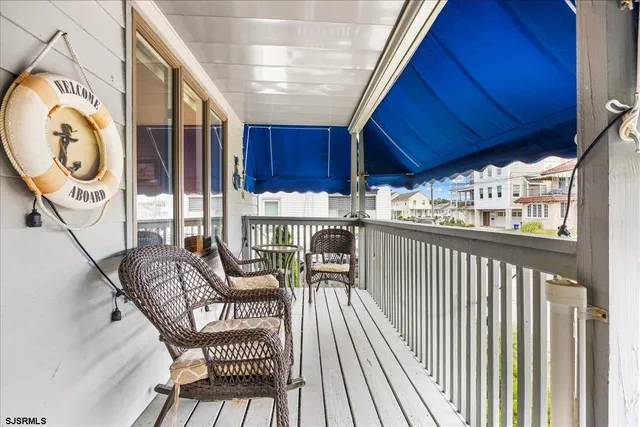 a view of a chairs and table in the balcony