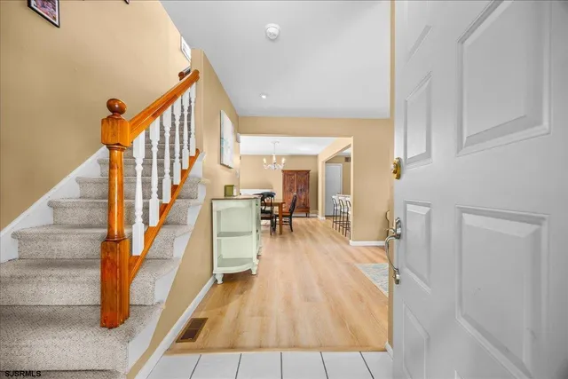 a view of a room with wooden floor and staircase