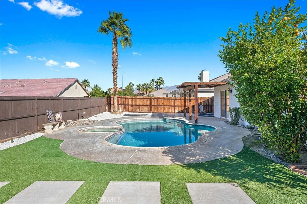 a view of a house with backyard sitting area and tub