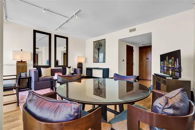 a living room with furniture a rug and a window