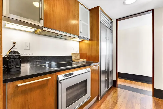 a kitchen with stainless steel appliances granite countertop a stove and a refrigerator