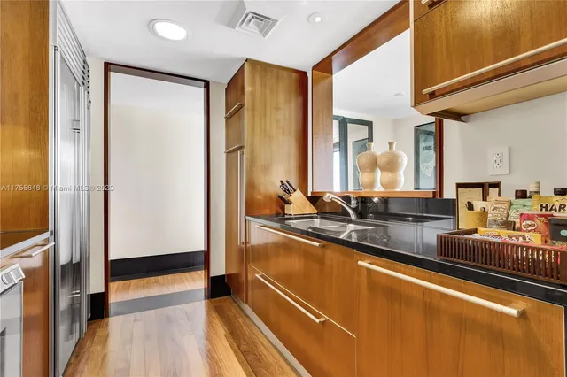 a kitchen with stainless steel appliances granite countertop a refrigerator and a sink