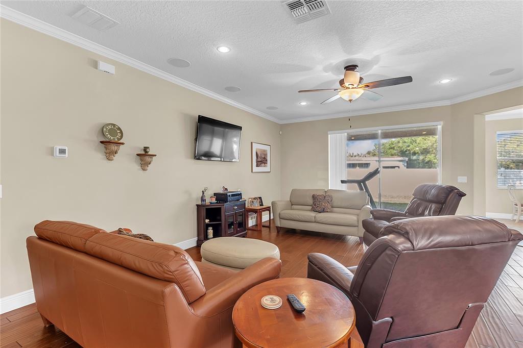 877 Strathmore Drive Orlando, FL 32803 - Photo 14 of 38 a living room with furniture ceiling fan and a window