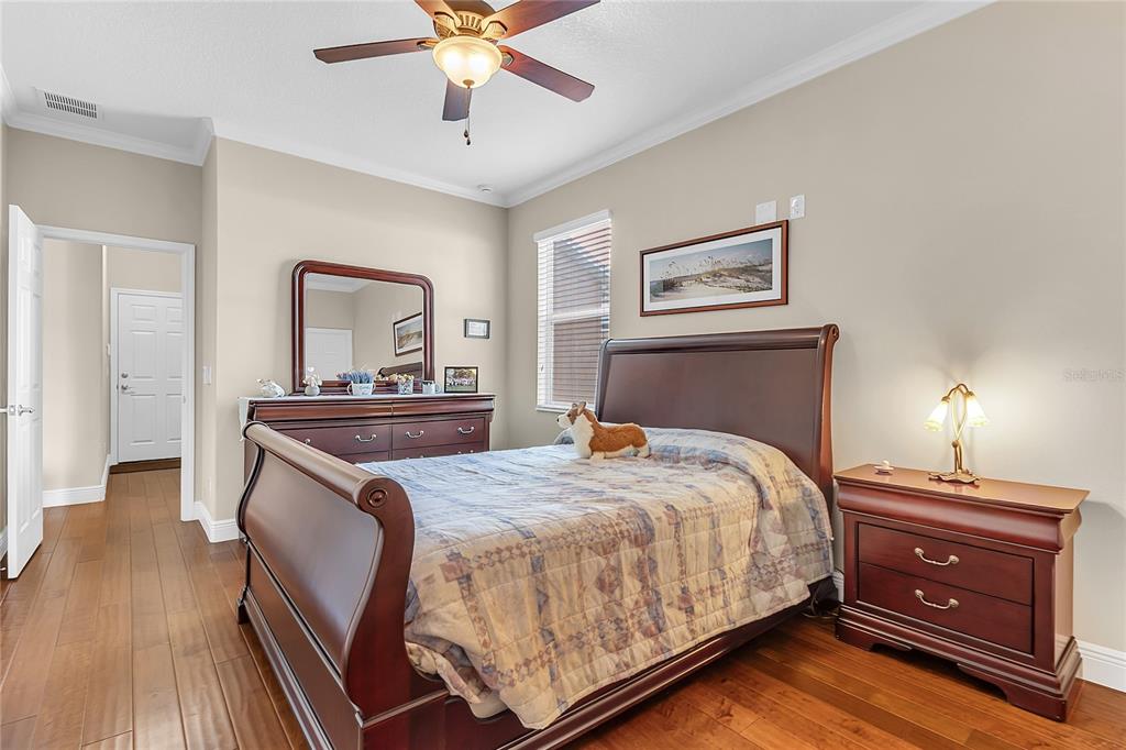 877 Strathmore Drive Orlando, FL 32803 - Photo 19 of 38 a bedroom with a bed and a dresser