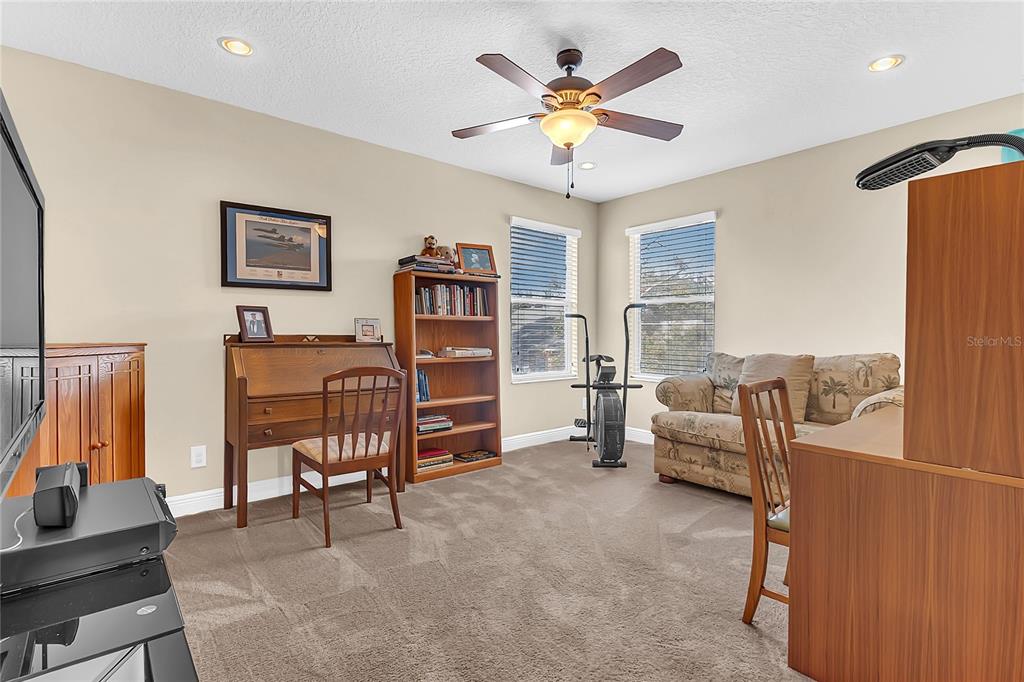 877 Strathmore Drive Orlando, FL 32803 - Photo 23 of 38 a living room with furniture and a flat screen tv