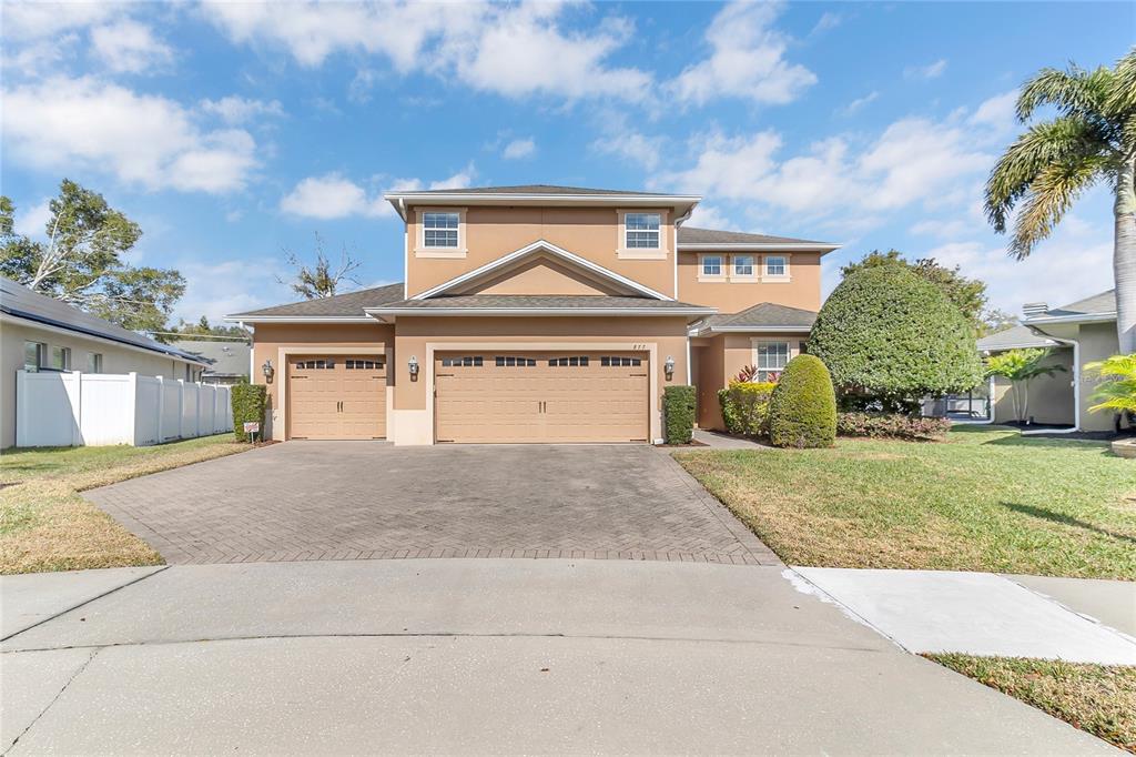 877 Strathmore Drive Orlando, FL 32803 - Photo 30 of 38 a front view of a house with a garden and garage