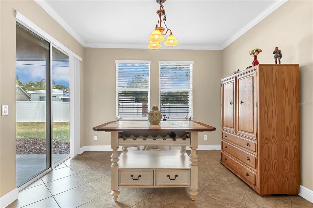 877 Strathmore Drive Orlando, FL 32803 - Photo 3 of 38 a kitchen with stainless steel appliances granite countertop a stove and a refrigerator