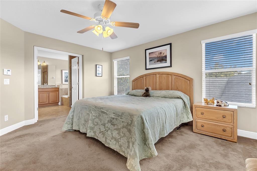 877 Strathmore Drive Orlando, FL 32803 - Photo 4 of 38 a bedroom with a bed and a chandelier