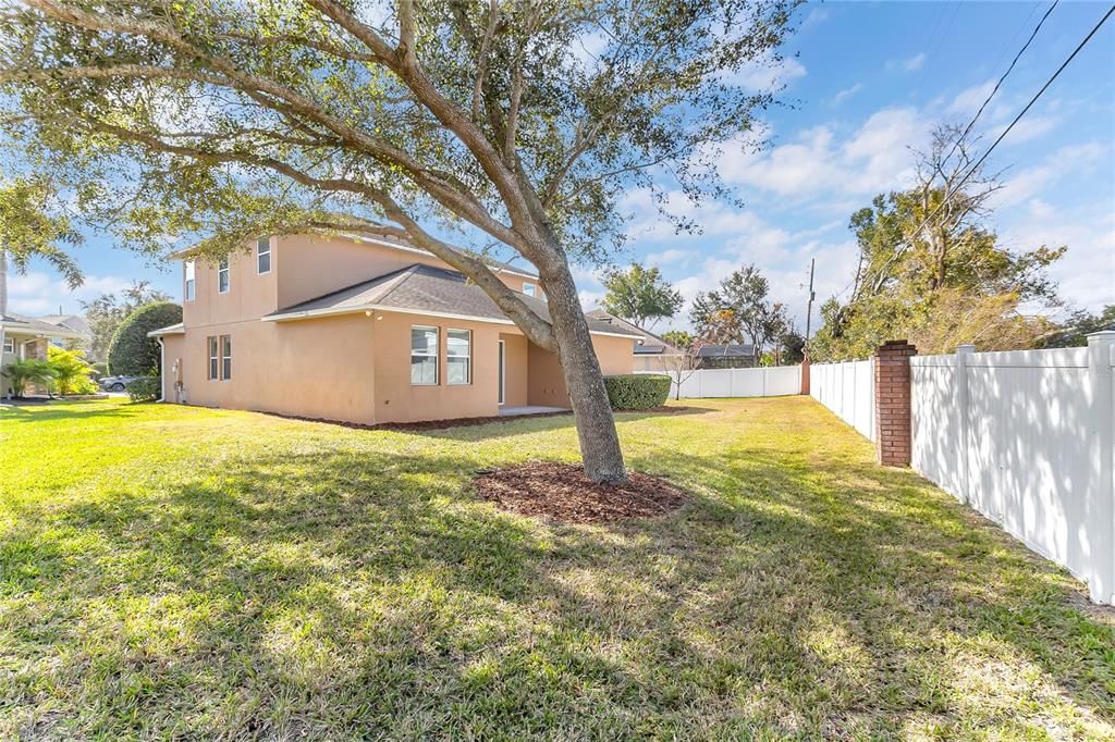 877 Strathmore Drive Orlando, FL 32803 - Photo 6 of 38 a view of an house with backyard and tree