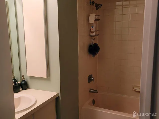 a bathroom with a tub sink and vanity