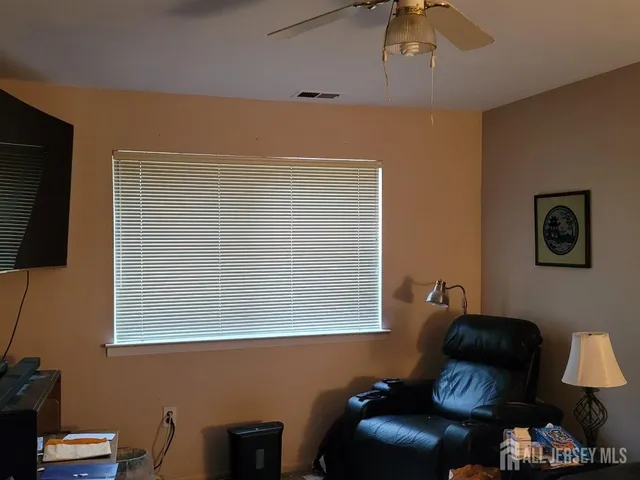 a blue chair sitting in front of a window