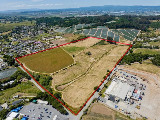 an aerial view of a house with a big yard