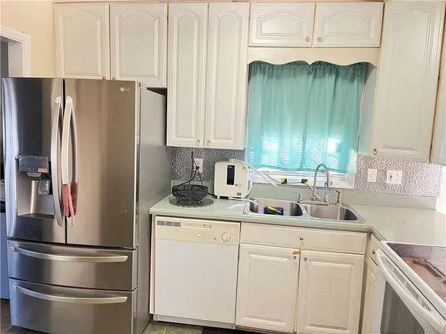 a bedroom with a bed and a potted plant