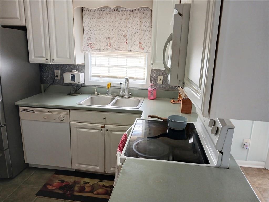 242 Lake Jodeco Road, Unit 242 Jonesboro, GA 30236 - Photo 19 of 45 a kitchen with sink refrigerator and window