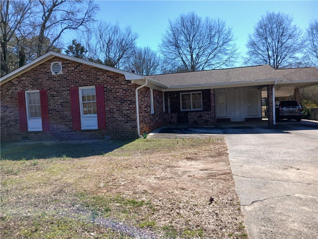 242 Lake Jodeco Road, Unit 242 Jonesboro, GA 30236 - Photo 7 of 45 a front view of a house with a yard covered in snow
