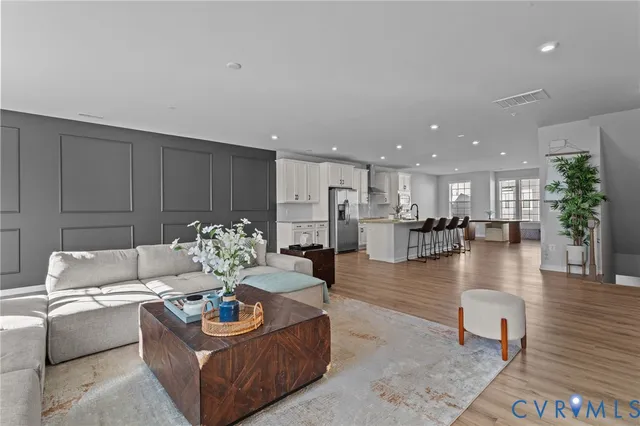 a living room with furniture kitchen view and a table
