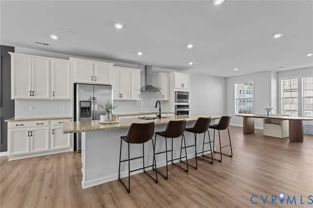 a open kitchen with white cabinets and stainless steel appliances