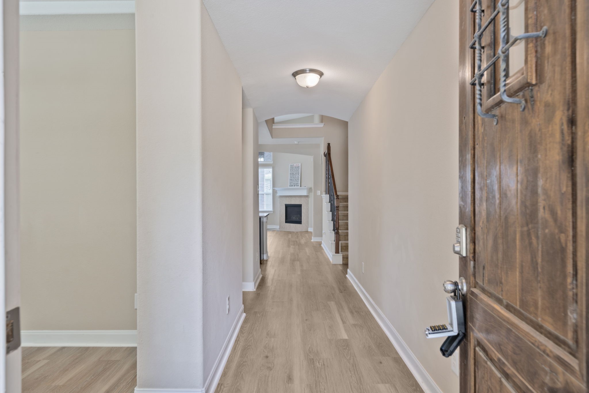 22523 Birch Ridge Meadow Drive Spring, TX 77389 - Photo 4 of 39 a view of a hallway with wooden floor and staircase