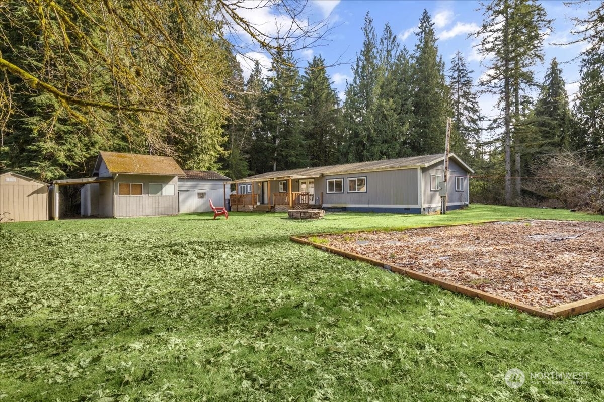 815 Carlson Road Snohomish, WA 98290 - Photo 2 of 21 a view of house with backyard and trees in the background