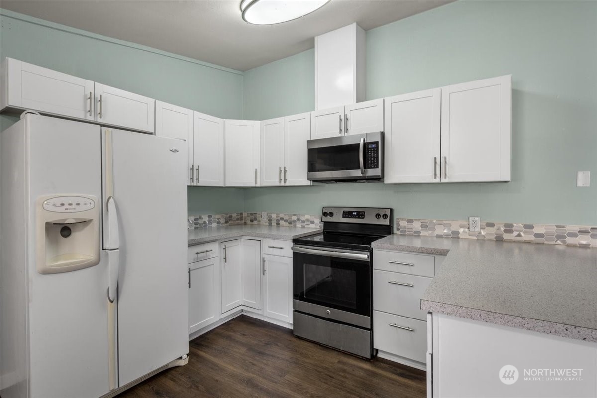 815 Carlson Road Snohomish, WA 98290 - Photo 5 of 21 a kitchen with stainless steel appliances white cabinets and a refrigerator