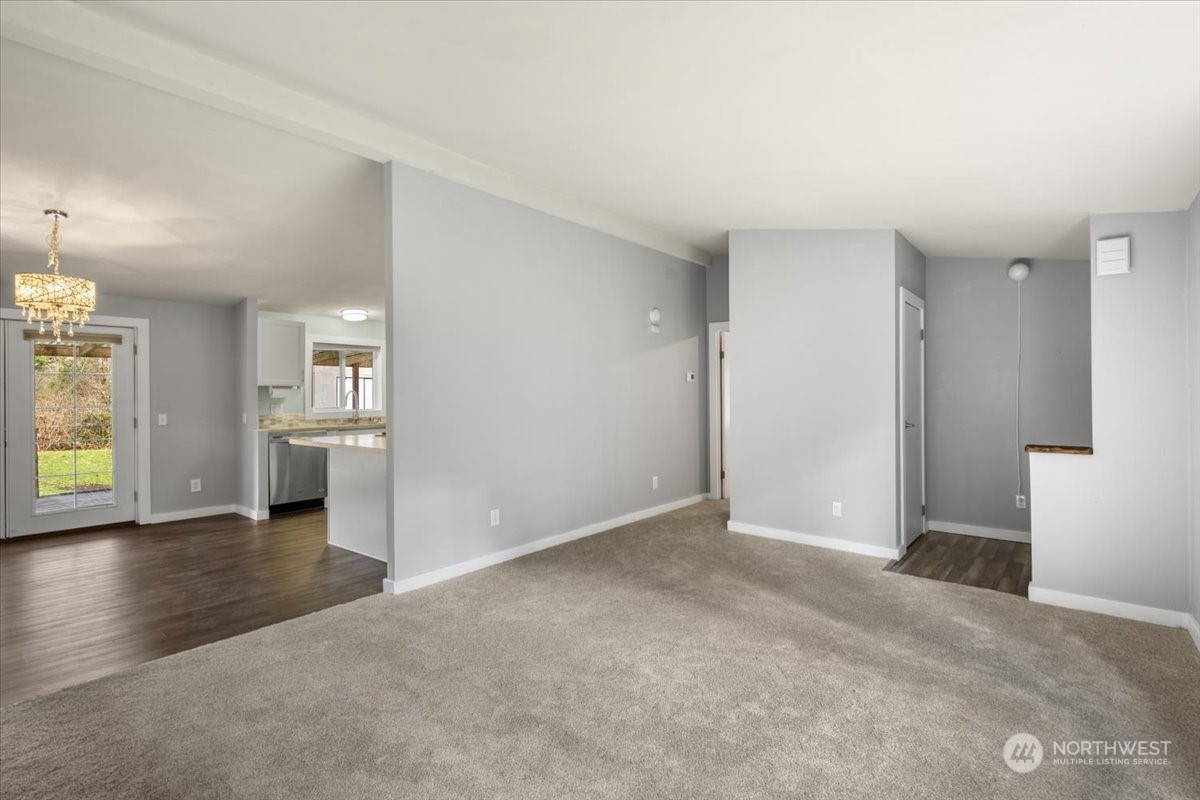 815 Carlson Road Snohomish, WA 98290 - Photo 9 of 21 an empty room with a kitchen and a sink