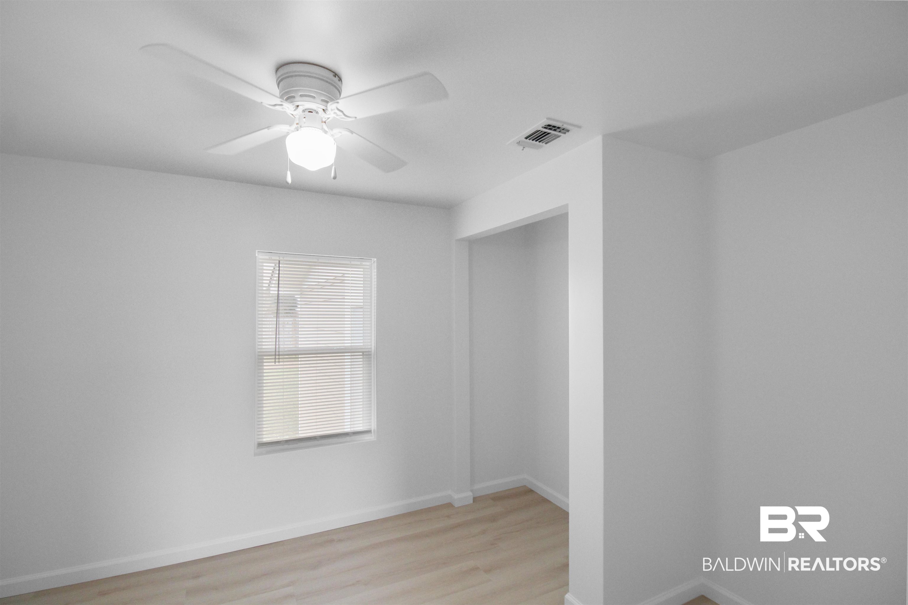 17622 Brewer Road Foley, AL 36535 - Photo 16 of 26 Empty room featuring a ceiling fan and light wood-style flooring