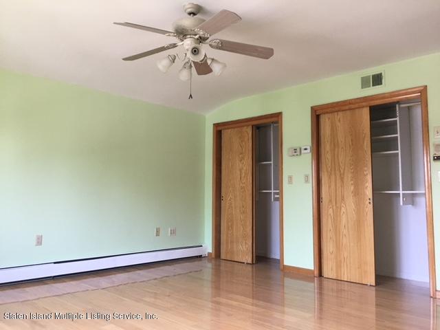 50 Beacon Place Staten Island, NY 10306 - Photo 23 of 28 an empty room with wooden floor closet and windows