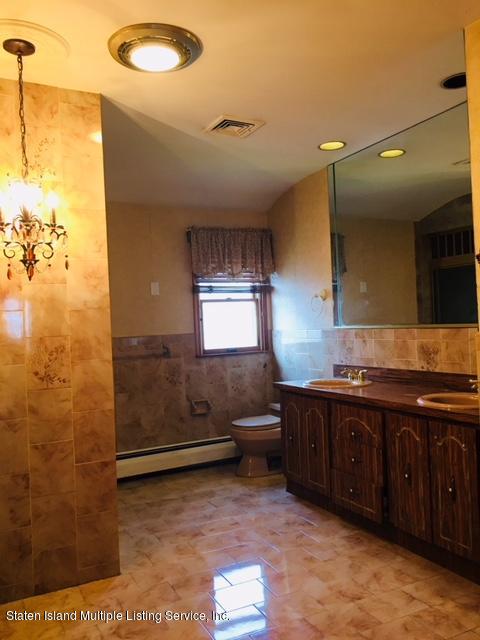 50 Beacon Place Staten Island, NY 10306 - Photo 25 of 28 a bathroom with a sink and mirror