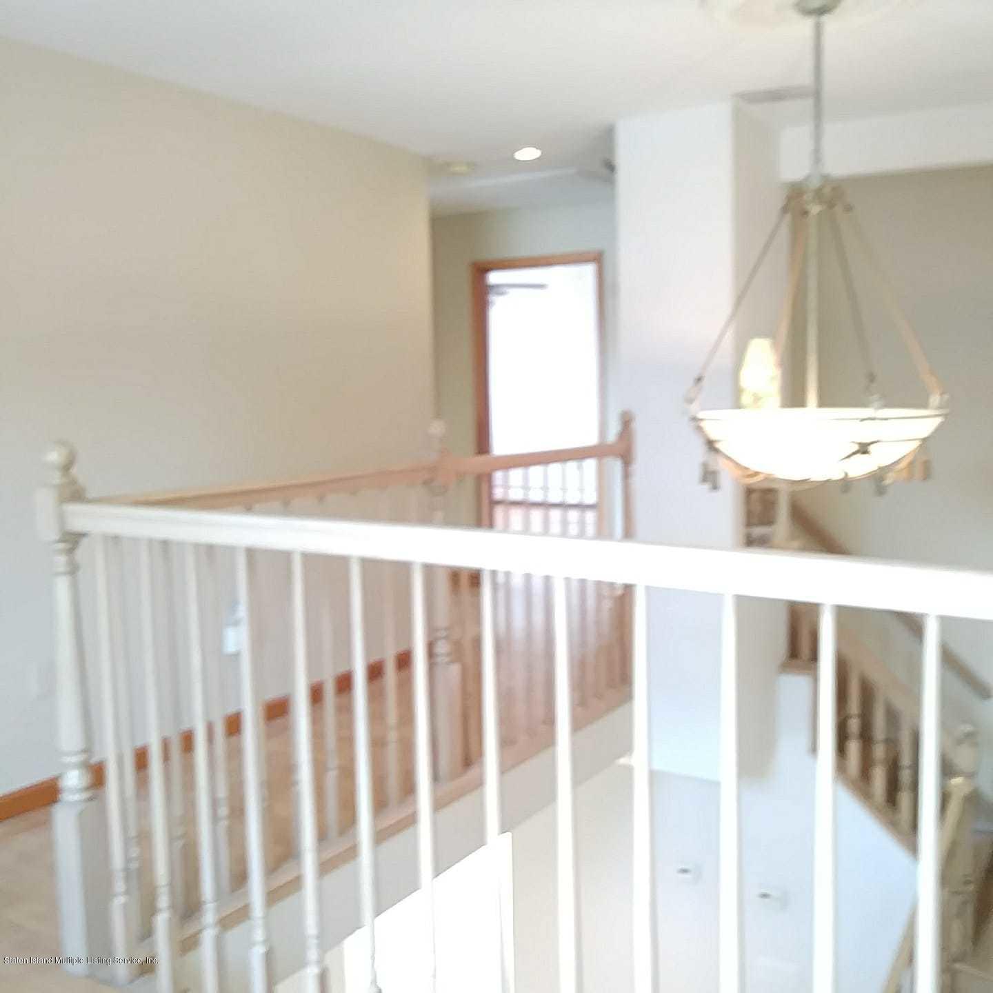 50 Beacon Place Staten Island, NY 10306 - Photo 28 of 28 a view of a bedroom with wooden floor and windows