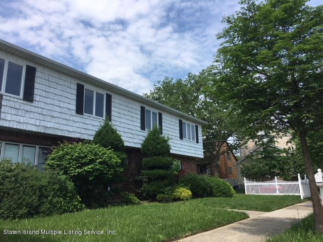 50 Beacon Place Staten Island, NY 10306 - Photo 3 of 28 a front view of a house with a yard