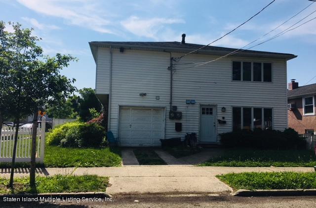 50 Beacon Place Staten Island, NY 10306 - Photo 5 of 28 a front view of a house with a yard
