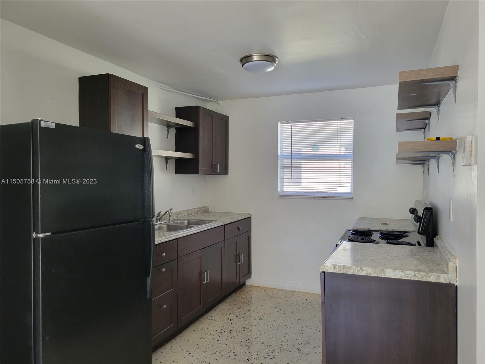 Little River Miami, FL 33138 - Photo 2 of 10 a kitchen with a refrigerator and a sink